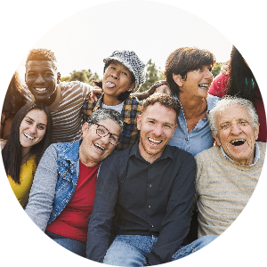 A group of friends of different ages and backgrounds smile for the camera.